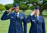 U.S. Air Force Staff Sgt. Johnnie Anderson and Airman 1st Class Andrew Titus, dental technicians with the 15th Aeromedical Squadron, salute a fallen U.S. servicemember's  gravemarker at the National Memorial Cemetery of the Pacific, Honolulu, Hawaii, Dec. 3, 2016. Anderson and Titus placed multiple flags during a commemoration ceremony honoring the courage, service and sacrifice of the U.S. military personnel who died during the attacks on Pearl Harbor and Oahu on Dec. 7, 1941. Dec. 7, 2016 marks the 75th anniversary of the attacks and the U.S. military and the State of Hawaii are hosting a series of remembrance events to honor the Pacific Theater's veterans. (U.S. Air Force photo by Tech. Sgt. James Stewart/Released)