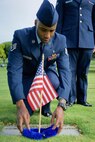 U.S. Air Force Staff Sgt. Johnnie Anderson, a dental technician with the 15th Aeromedical Squadron, places a lei around a commemorative U.S. flag near a gravemarker at the National Memorial Cemetery of the Pacific, Honolulu, Hawaii, Dec. 3, 2016. Anderson placed multiple flags during a commemoration ceremony honoring the courage, service and sacrifice of the U.S. military personnel who died during the attacks on Pearl Harbor and Oahu on Dec. 7, 1941. Dec. 7, 2016 marks the 75th anniversary of the attacks and the U.S. military and the State of Hawaii are hosting a series of remembrance events to honor the Pacific Theater's veterans. (U.S. Air Force photo by Tech. Sgt. James Stewart/Released)