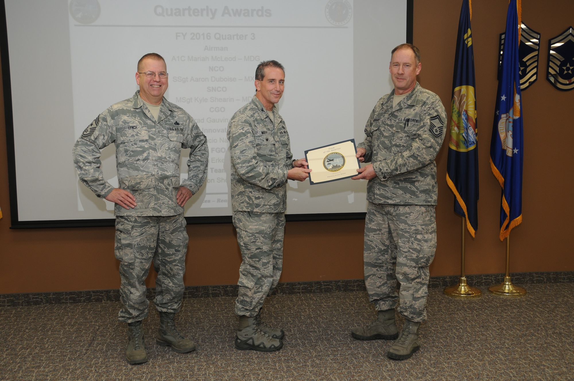 120th Airlift Wing Vice Commander Col. Thomas Mora and 120th AW Command Chief Master Sgt. Steven Lynch presented the Fiscal Year 2016 3rd quarter award winners for the 120th Airlift Wing of the Montana Air National Guard during the Stand-up Briefing held in the Larsen Room of the wing headquarters building Nov. 4, 2016. Senior Master Sgt. Wayne Bonderenko accepted the  Team of the Quarter Award on behalf of the 120th Maintenance Group propulsion shop.