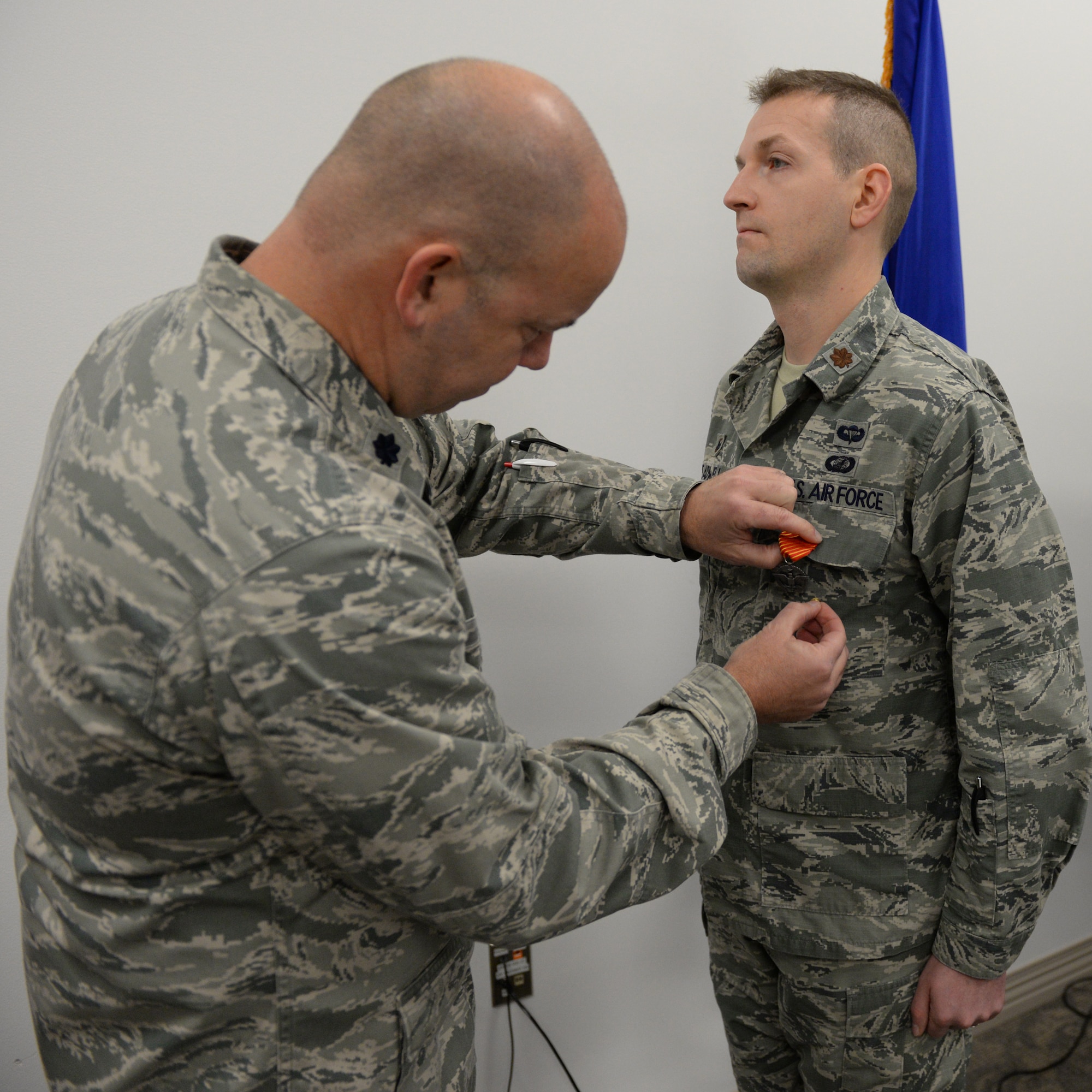 U.S. Air Force Lt. Col. William Davis, 157th Air Refueling Wing vice wing commander, left, presents the Air Force Combat Action Medal to Maj. Scott M. Treadwell, 157th Comptroller Flight commander, Pease Air National Guard Base, N.H., Dec. 3, 2016.  Treadwell received the award for participation in combat in connection with military operations Sept. 25, 2005 while serving as a first lieutenant in the U.S. Army during Operation Iraqi Freedom. (U.S. Air National Guard photo by Staff Sgt. Curtis J. Lenz)