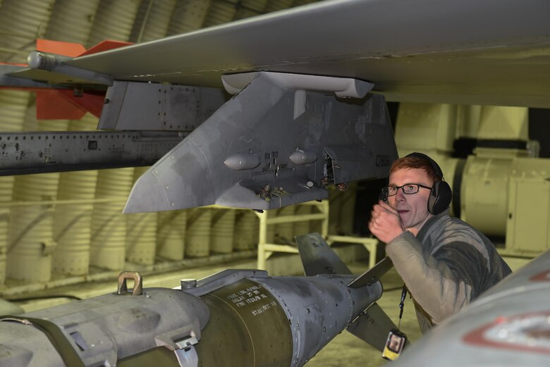 Staff Sgt. Kenneth Gullette, 35th Aircraft Maintenance Unit weapons load crew chief, guides a Joint Direct Attack Munition GBU-31 onto the wing of an F-16 Fighting Falcon at Kunsan Air Base, Republic of Korea, Nov. 30, 2016. Members of the 35th AMU safely prepare F-16’s for a variety of missions, which feed into the 8th Fighter Wings priorities of defending the base and being postured to respond to any threats. (U.S. Air Force photo by Senior Airman Michael Hunsaker/Released)
