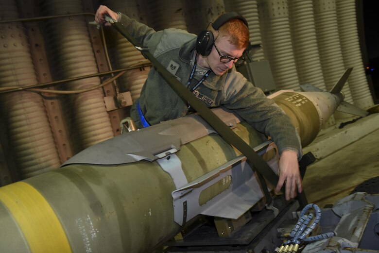 Staff Sgt. Kenneth Gullette, 35th Aircraft Maintenance Unit weapons load crew chief, straps a Joint Direct Attack Munition GBU-31 onto an MJ-1 Lift Truck at Kunsan Air Base, Republic of Korea, Nov. 30, 2016. Members of the 35th AMU train to safely load, unload, and properly position munitions onto F-16 Fighting Falcons. (U.S. Air Force photo by Senior Airman Michael Hunsaker/Released)