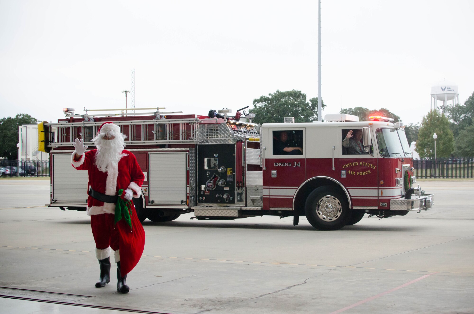 Santa arrives at the 403rd Wing children's holiday party on a fire truck Dec. 3. The annual event also included bounce houses, crafts and food. (U.S. Air Force photo/Staff Sgt. Heather Heiney)