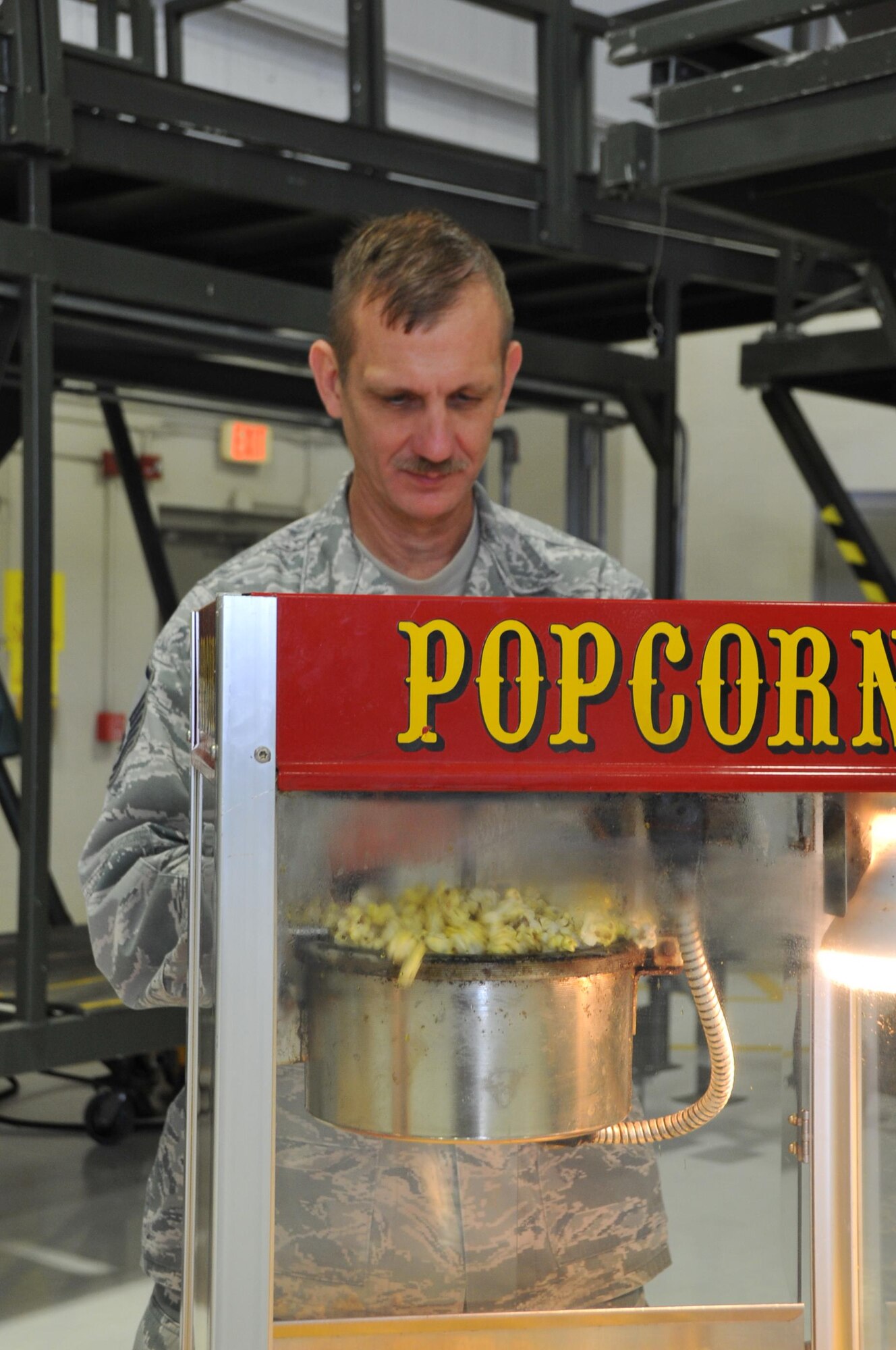 Master Sgt. Stephen Strausbaugh, a 403rd Maintenance Squadron member, prepares the popcorn for the 403rd Wing children's holiday party Dec. 3, 2016.  (U.S. Air Force photo/Master Sgt. Jessica Kendziorek)