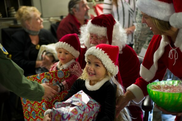Members of the 315th Operations Group, along with their family and friends, enjoy a visit from Santa Claus Dec. 3, 2016 at Joint Base Charleston, South Carolina. The event was part of an annual holiday gathering aimed at boosting morale and family wellness (U.S. Air Force photo by Senior Airman Jonathan Lane).