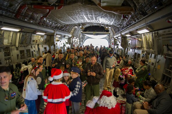 Members of the 315th Operations Group, along with their family and friends, enjoy a visit from Santa Claus Dec. 3, 2016 at Joint Base Charleston, South Carolina. The event was part of an annual holiday gathering aimed at boosting morale and family wellness (U.S. Air Force photo by Senior Airman Jonathan Lane).
