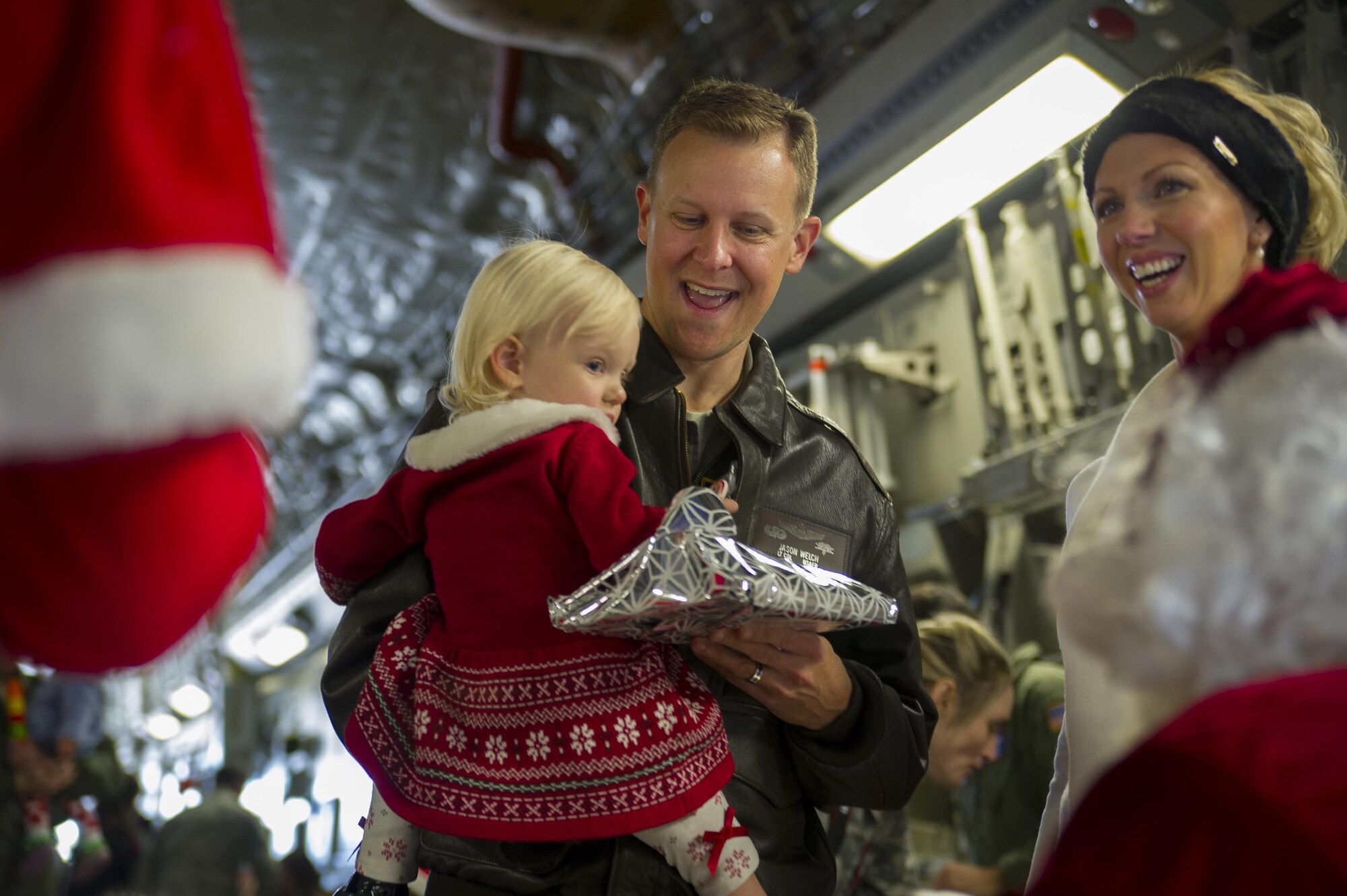 Members of the 315th Operations Group, along with their family and friends, enjoy a visit from Santa Claus Dec. 3, 2016 at Joint Base Charleston, South Carolina. The event was part of an annual holiday gathering aimed at boosting morale and family wellness (U.S. Air Force photo by Senior Airman Jonathan Lane).