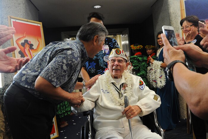 The governor of Hawaii, David Ige, greets Pearl Harbor survivor and former soldier Alexander Horanzy upon arrival at Honolulu, Dec. 3, 2016. Horanzy was on an honor flight from Los Angeles that carried 32 Pearl Harbor survivors and other veterans to Hawaii for commemorations for the 75th anniversary of the infamous attack. DoD photo by Lisa Ferdinando