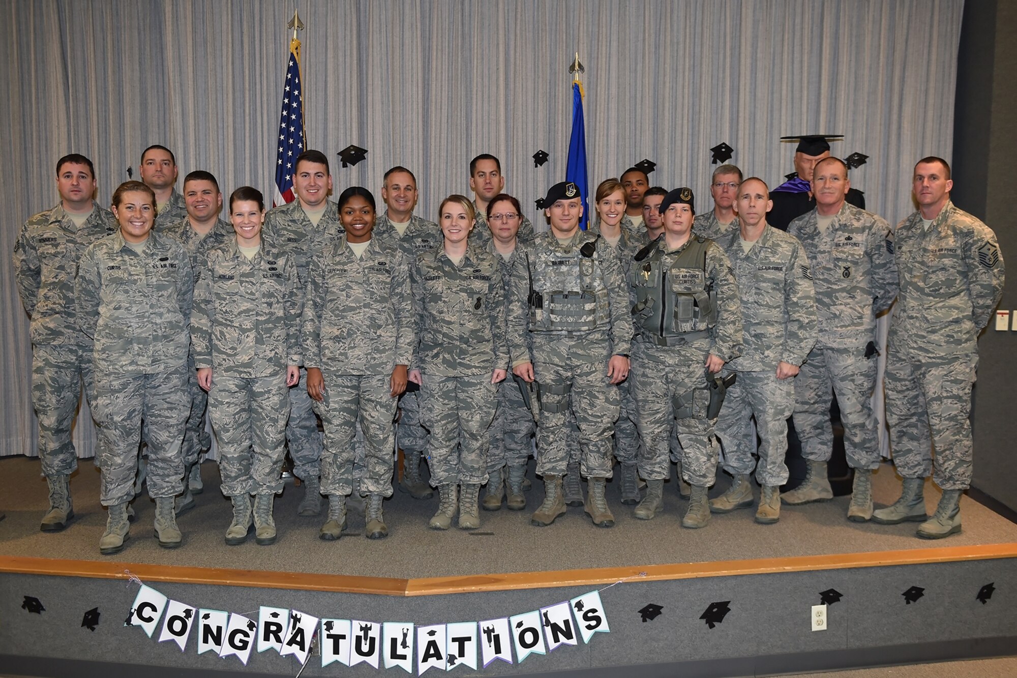 Community College of the Air Force graduates pose for a photo during a CCAF graduation ceremony at Grissom Air Reserve Base, Ind., Dec. 4, 2016. The College annually awards over 22,000 associate degrees from 68 degree programs to Air Force members. (U.S. Air Force photo/Staff Sgt. Jami K. Lancette)