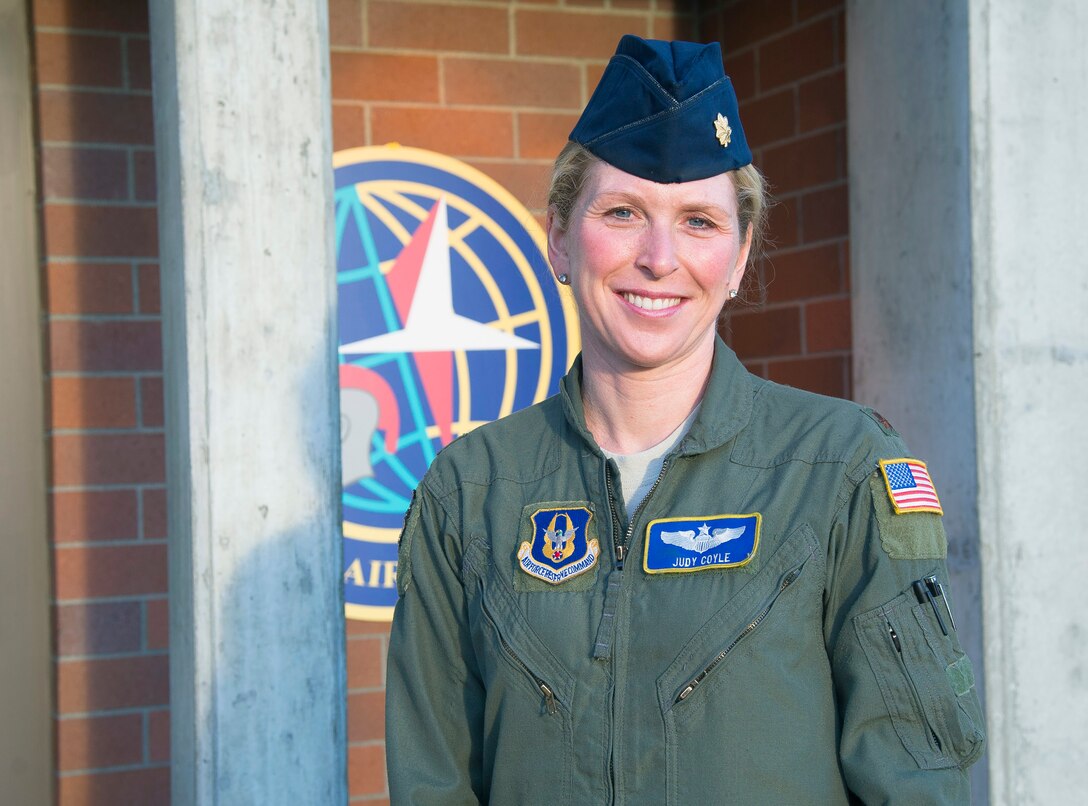 Maj. Judy Coyle, 728th Airlift Squadron C-17 pilot, poses for a photo in front of her squadron Dec. 12, 2016. Coyle, who balances fitness with two flying jobs, won first place in the Armed Forces Triathlon against all branches of the U.S. military and Canada in June 2016. (U.S. Air Force Reserve photo by Staff Sgt. Madelyn McCullough)