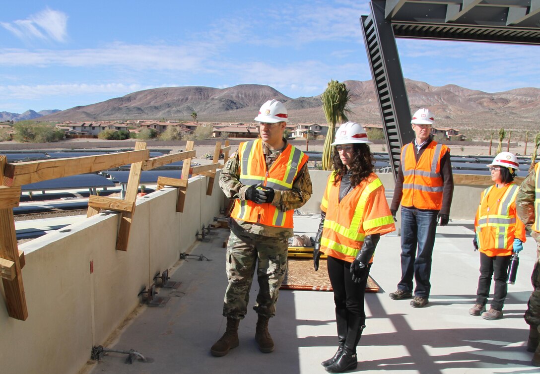 Maj. Jefferey Beeman (l), project program manager and Cheree Peterson (r), director of programs, U.S. Army Corps Engineers South Pacific Division, and the senior executive project manager for the Fort Irwin Weed Army Hospital replacement construction project (r) observe on-going  construction activites from the hospital command suite patio at the new Weed Army Community Hospital construction project, Ft. Irwin, California. Peterson hosted the project’s Senior Executive Review Group quarterly briefing here Dec. 1.