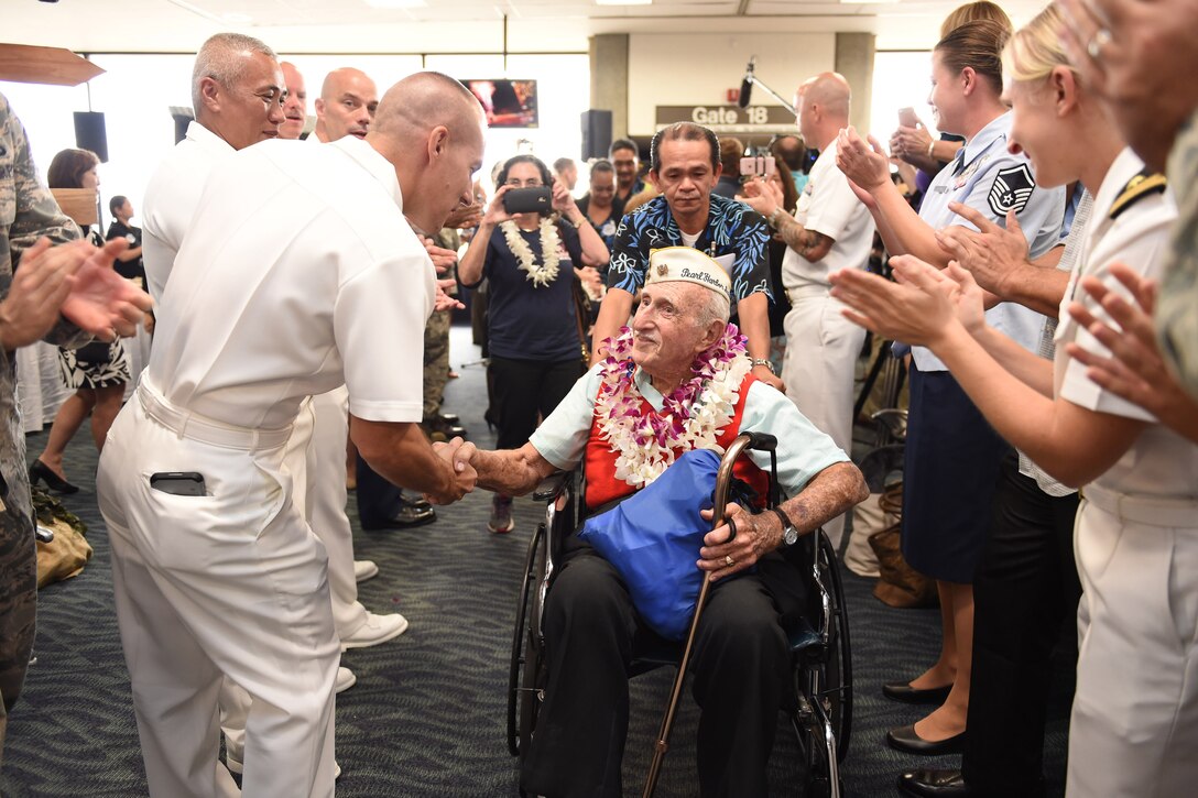 Service members greet World War II veterans and Pearl Harbor survivors as they arrive to mark the 75th anniversary of the attacks, in Honolulu, Dec. 3, 2016. Navy photo by Petty Officer 1st Class Nardel Gervacio