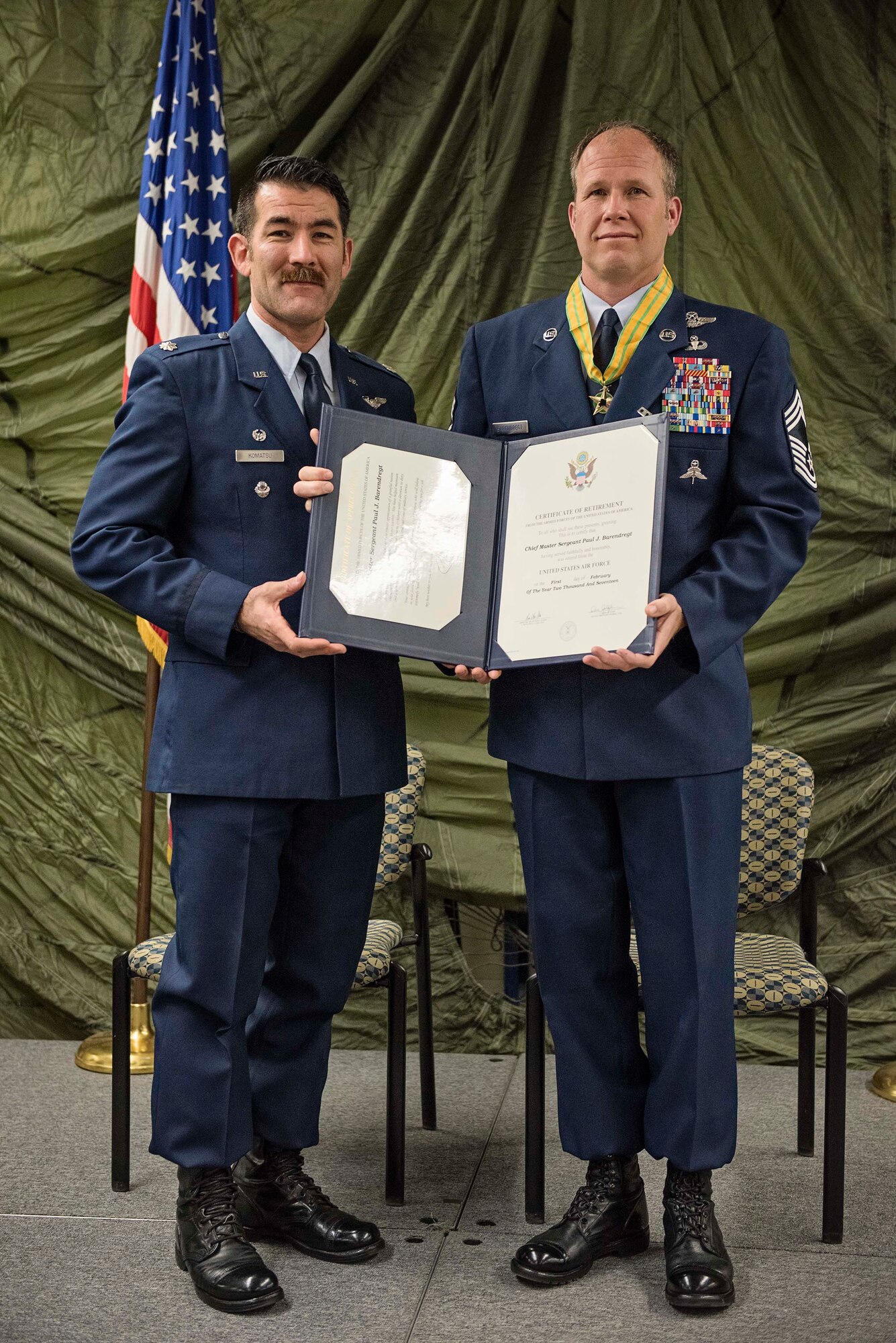 JOINT BASE ELMENDORF-RICHARDSON, Alaska -- Lt. Col. Matthew Komatsu, commander of the 212th Rescue Squadron, Alaska Air National Guard, presents a certificate of retirement to Chief Master Sgt. Paul Bear Barendregt, a pararescueman and chief enlisted manager for the 212 RQS, during a retirement ceremony at the 212th's headquarters building here Dec. 3, 2016. Through his skill and commitment Barendregt exemplified the motto of the Air Force Pararescueman: These things we do, that others may live. (U.S. Air National Guard photo by Staff Sgt. Edward Eagerton/released)