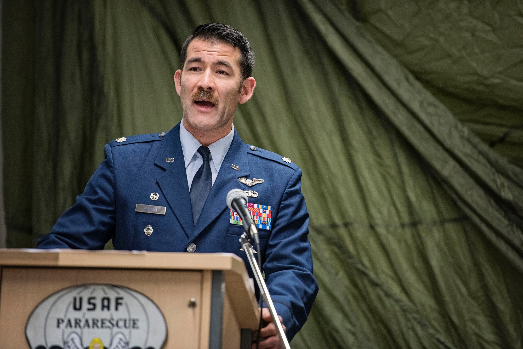JOINT BASE ELMENDORF-RICHARDSON, Alaska -- Lt. Col. Matthew Komatsu, commander of the 212th Rescue Squadron, Alaska Air National Guard, gives a speech during the retirement ceremony of Chief Master Sgt. Paul Bear Barendregt, a pararescueman and chief enlisted manager for the 212 RQS, here Dec. 3, 2016. Through his skill and commitment Barendregt exemplified the motto of the Air Force Pararescueman: These things we do, that others may live. (U.S. Air National Guard photo by Staff Sgt. Edward Eagerton/released)