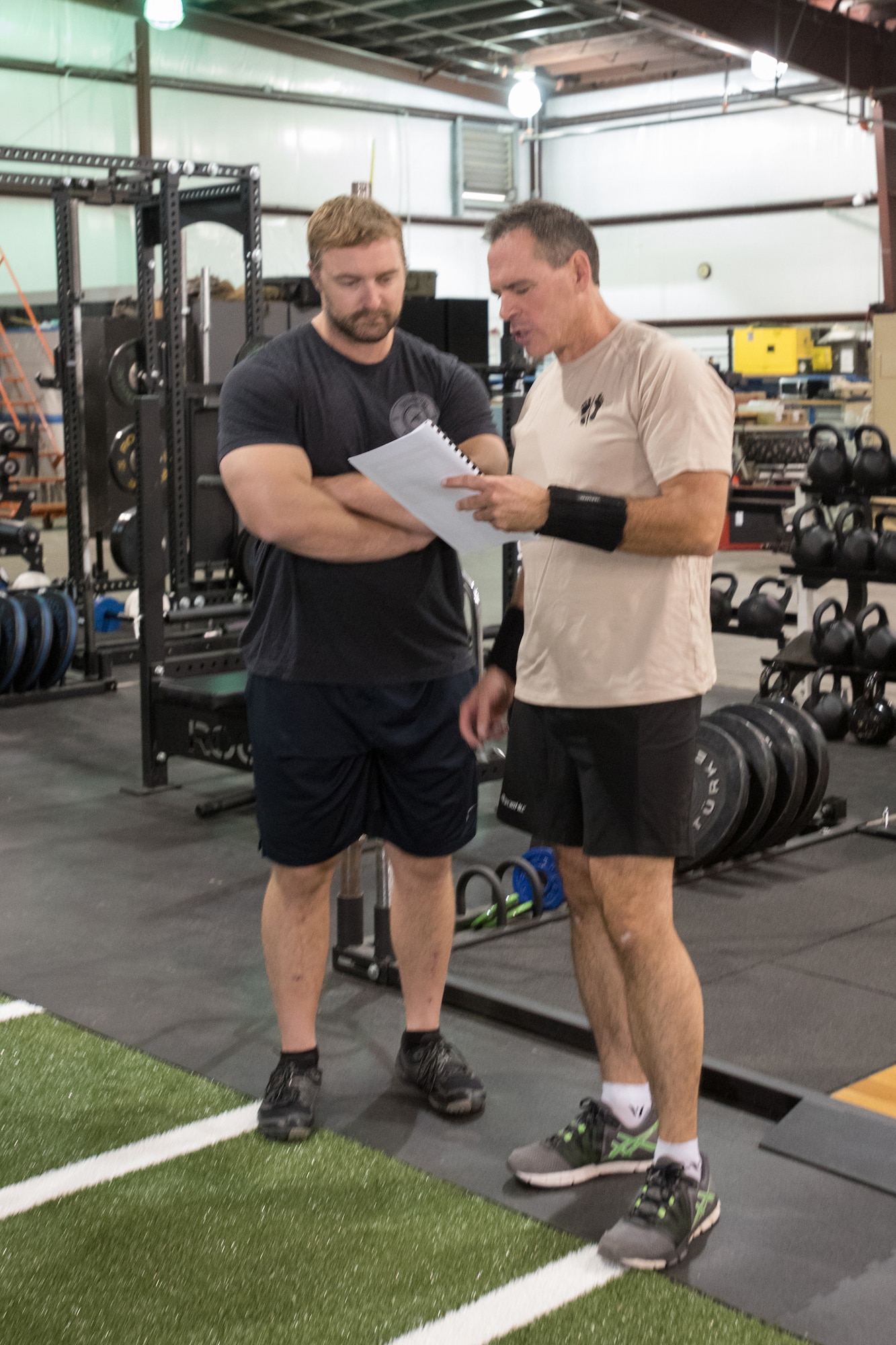 Lt. Col. Sean McLane, commander of the 123rd Special Tactics Squadron, looks over his personal workout and rehabilitation regimen during a session at the Human Performance Program facility on the Kentucky Air National Guard Base in Louisville, Ky., Oct. 14, 2016. Evaluating his progress is Will Lawson, the program’s lead athletic trainer and strength coach, who helped design McLane’s daily workout routine. (U.S. Air National Guard photo by Tech. Sgt. Vicky Spesard)
