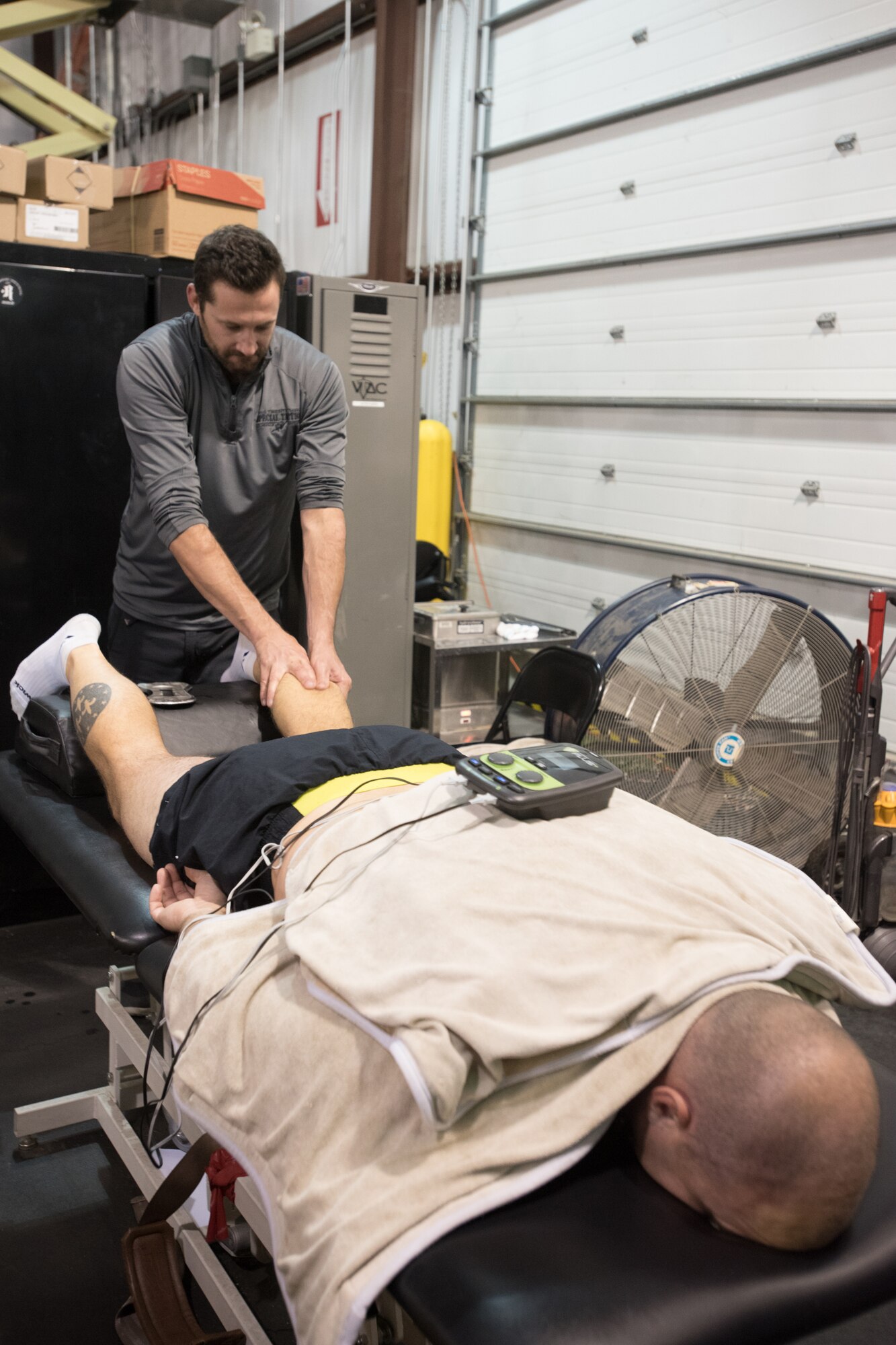 Jake Kilbride, a licensed massage therapist, administers a soft-tissue massage to 2nd Lt. Russ LeMay, a special tactics operator with the 123rd Special Tactics Squadron, at the Human Performance Program facility on the Kentucky Air National Guard Base in Louisville, Ky., Oct. 14, 2016. Kilbride, an assistant strength coach and facility manager, is part of a three-member staff that develops personalized strength and conditioning programs and rehabilitation plans for squadron operators. (U.S. Air National Guard photo by Tech. Sgt. Vicky Spesard)
