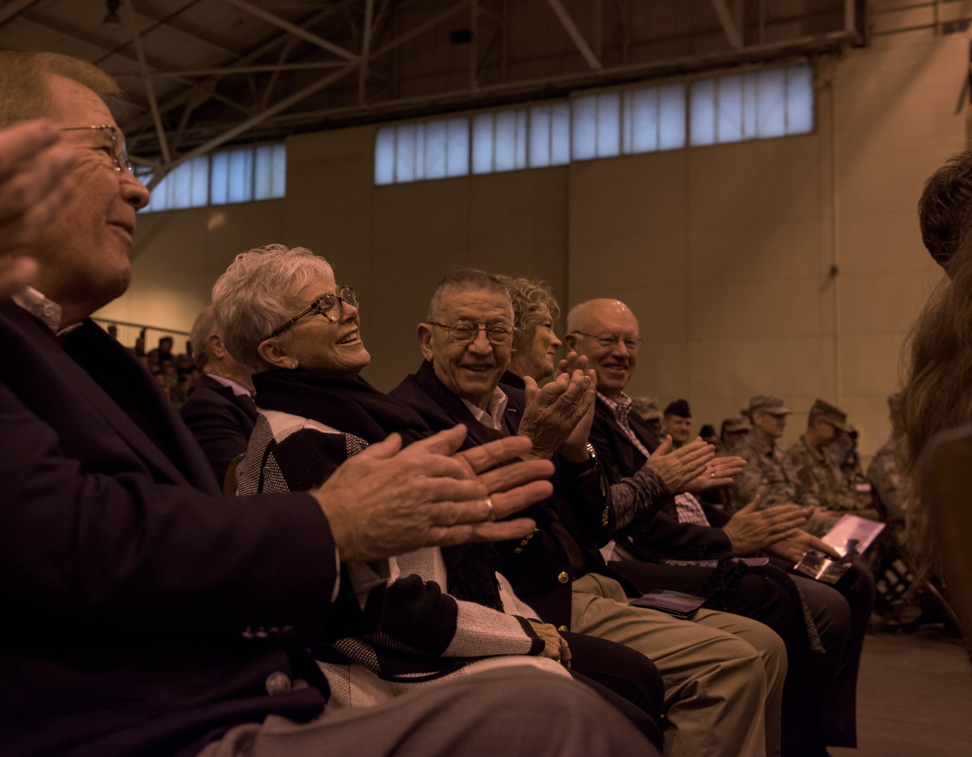 Retired Maj. Gen. Stanley Newman, former 137th Special Operations Wing commander, and retired Maj. Gen. Rita Aragon, Oklahoma Secretary of Veterans of Affairs, interact in the audience of the re-designation ceremony at the 137th Special Operations Wing at Will Rogers Air National Guard Base, Oklahoma City, Dec. 3, 2016. The ceremony marks the official transition of the Wing from its former air refueling mission to its current special operations mission, making the Wing the second Air National Guard wing to be a part of AFSOC and the only U.S. Air Force entity to fly and maintain the MC-12W. (U.S. Air National Guard photo by Tech. Sgt. Caroline Essex)