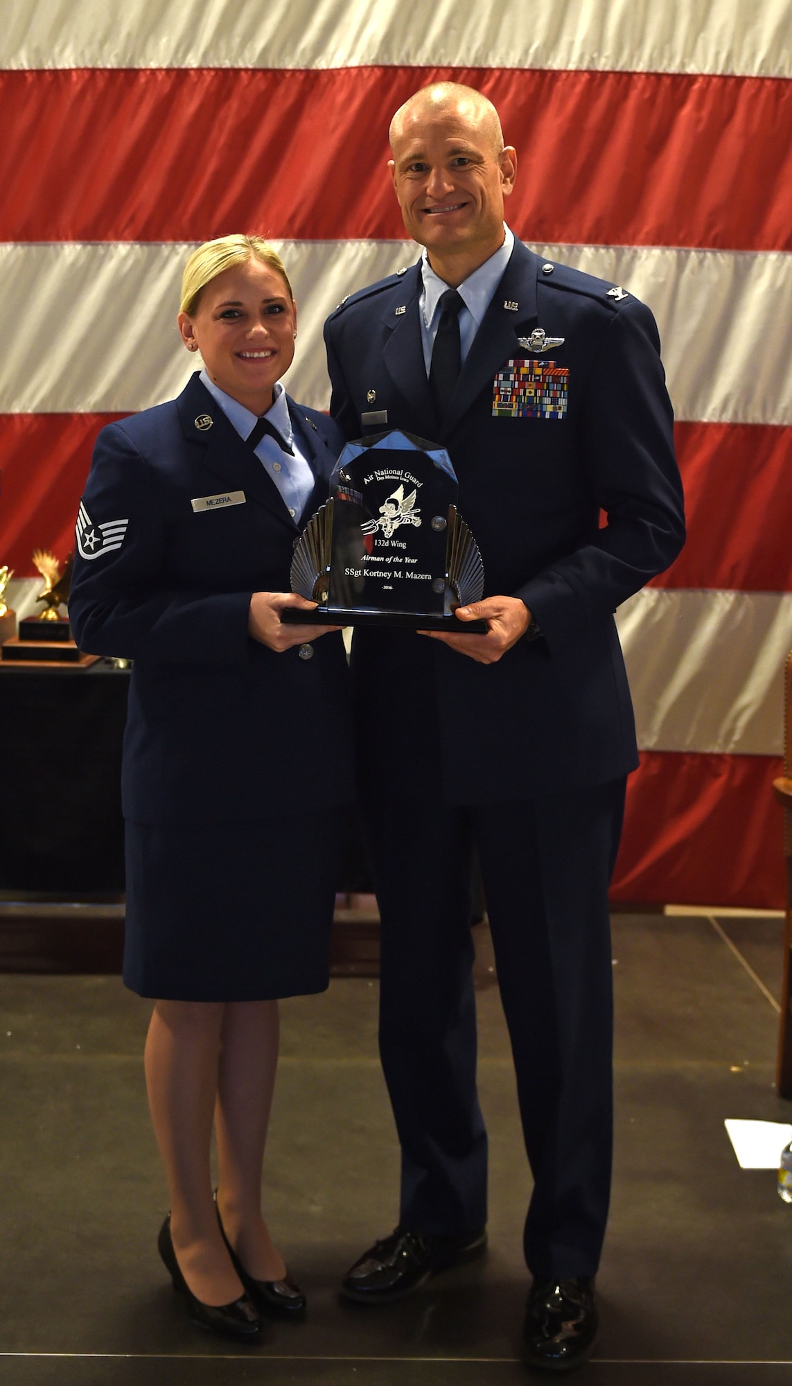 Staff Sgt. Kortney M. Mazera receives the 132d Wing Airman of the Year Award from Col. Shawn Ford, commander 132d Wing on November 5, 2016 at the Des Moines Airbase. The award presentation was part of the 132d Wing's annual awards ceremony. (U.S. Air National Guard photo by Staff Sgt. Michael J. Kelly)