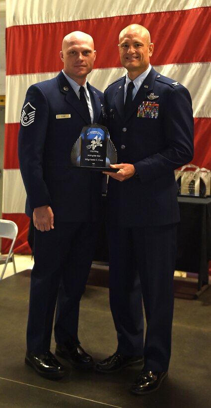 Master Sgt. Justin C. Coop receives the 132d Wing NCO of the Year Award from Col. Shawn Ford, commander 132d Wing on November 5, 2016 at the Des Moines Airbase. The award presentation was part of the 132d Wing's annual awards ceremony. (U.S. Air National Guard photo by Staff Sgt. Michael J. Kelly)