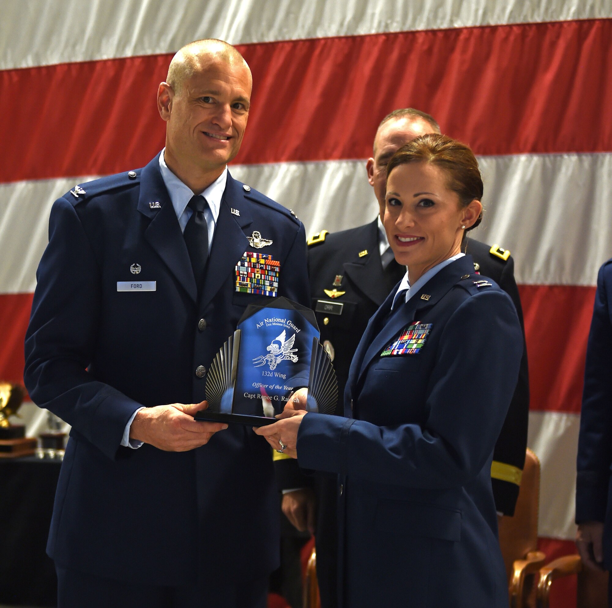 Capt. Renee Rausch receives the 132d Wing Officer of the Year Award from Col. Shawn Ford, commander 132d Wing on November 5, 2016 at the Des Moines Airbase. The award presentation was part of the 132d Wing's annual awards ceremony. (U.S. Air National Guard photo by Staff Sgt. Michael J. Kelly)