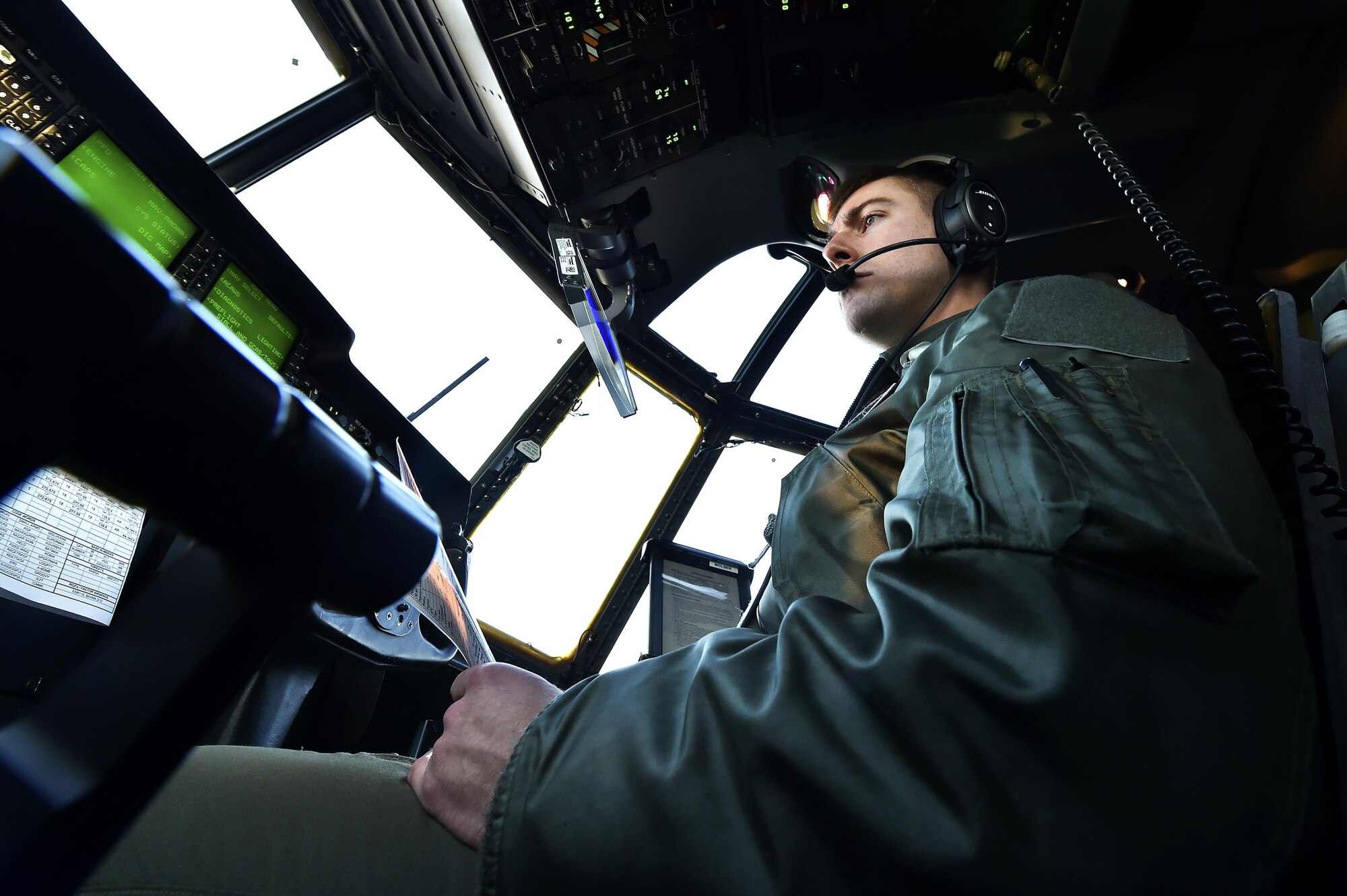 U.S. Air Force Capt. Peter Wolber, 37th Airlift Squadron co-pilot, conducts his pre-flight checklist before an air drop mission at Ramstein Air Base, Germany, Nov. 30, 2016. Wolber flew as the co-pilot on the mission, where more than 50 NATO service members parachuted out of the C-130J Super Hercules. (U.S. Air Force photo by Senior Airman Jonathan Bass)