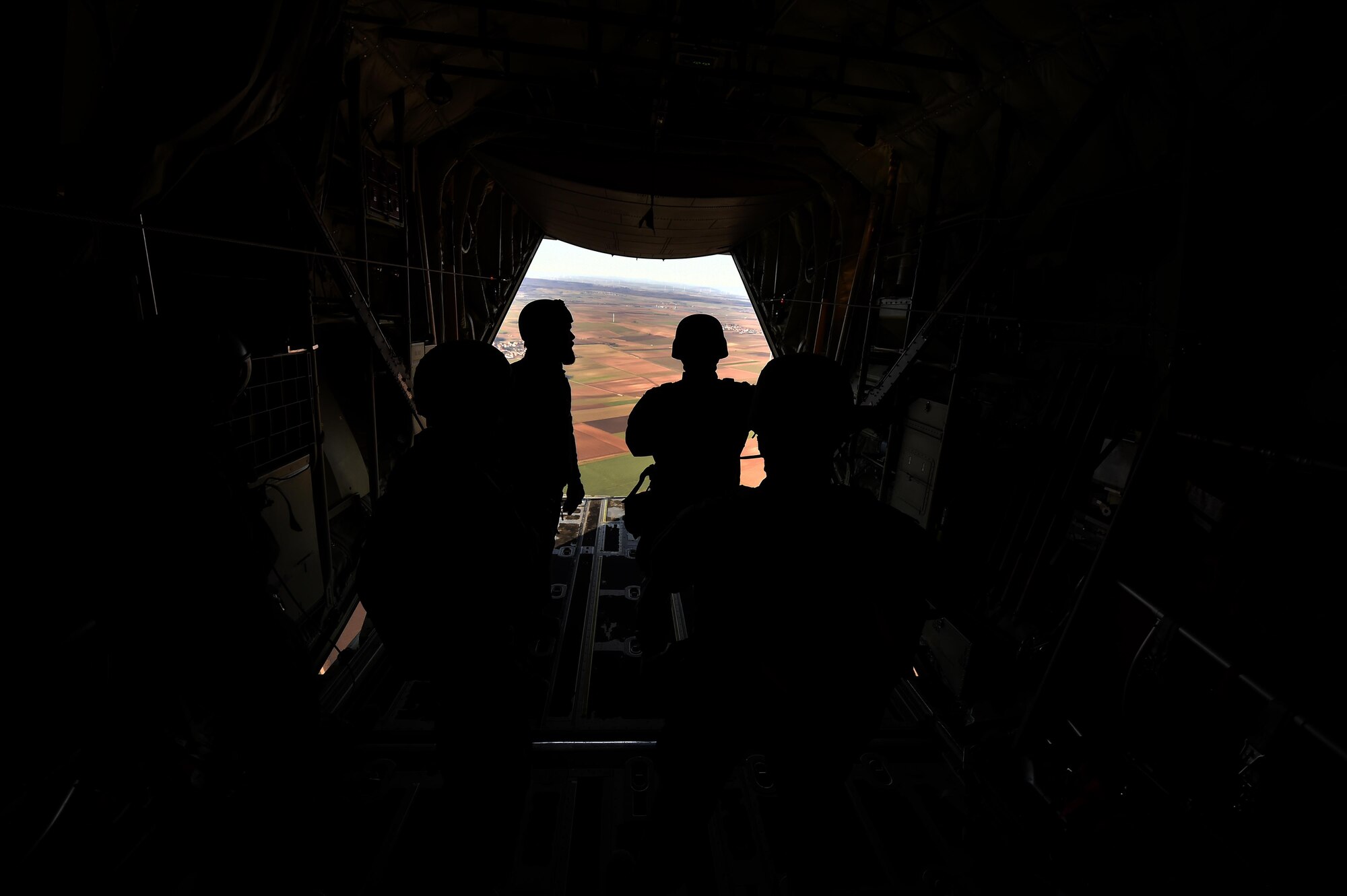NATO service members wait to jump out of a C-130J Super Hercules assigned to the 37th Airlift Squadron over the skies of Germany, Nov. 30, 2016. As part of International Jump Week, Ramstein Air Base assisted by providing aircraft for the paratroopers to jump from. (U.S. Air Force photo by Senior Airman Jonathan Bass)