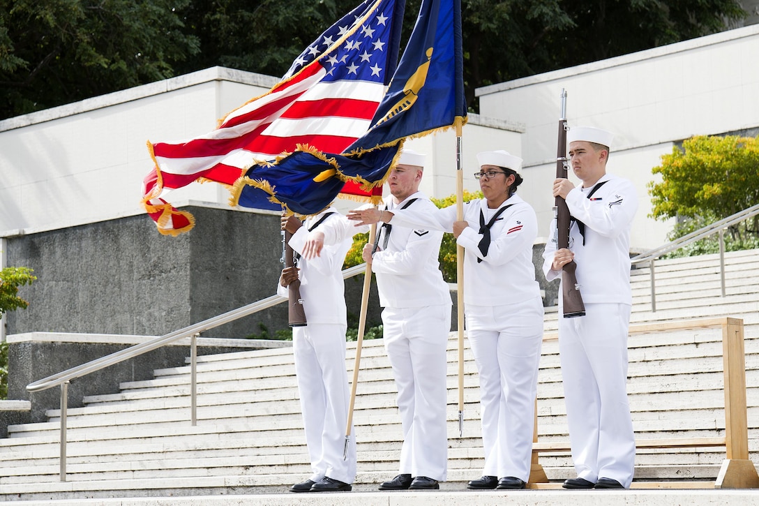 Joint Base Pearl Harbor-Hickam honors and ceremonial guard present the colors during a wreath-laying ceremony at the National Memorial Cemetery of the Pacific in Honolulu, Hawaii, Dec. 2, 2016. Navy photo by Petty Officer 2nd Class Gabrielle Joyner