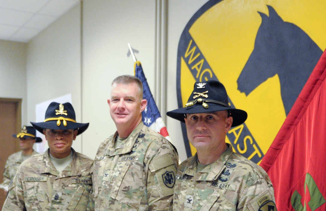 Command Sgt. Maj. Jill Crosby, Col. Rick Ellis and Col. Chris Colavita pose for a picture following the award ceremony. 