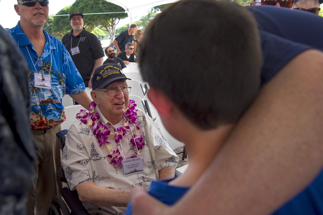 Pearl Harbor survivor Lauren Bruner, center, visits with attendees after a ceremony to honor the fallen men of the battleship USS Arizona at the National Memorial Cemetery of the Pacific in Honolulu, Hawaii, Dec. 2, 2016. Bruner escaped the burning USS Arizona on Dec. 7, 1941, by climbing a rope to a neighboring ship. Navy photo by Petty Officer 2nd Class Gabrielle Joyner