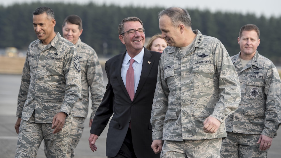 Defense Secretary Ash Carter speaks with Air Force Lt. Gen. Jerry Martinez, commander of U.S. Air Forces Japan and 5th Air Force, after arriving at Yokota Air Base, Japan. Carter is on an around-the-world trip to thank deployed service members, meet with regional partners and advance DoD priorities.