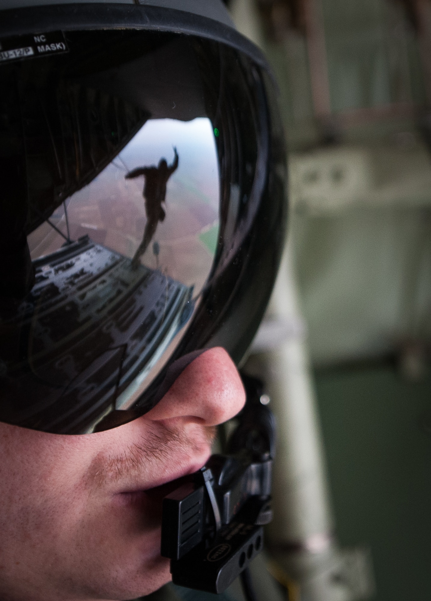 Senior Airman Patrick Cassidy, 37th Airlift Squadron loadmaster, observes as NATO allied nation paratroopers jump out of a C-130J Super Hercules during an International Jump Week exercise over Germany Dec. 1, 2016. Cassidy and the rest of the crew, stationed at Ramstein Air Base, assisted in the exercise by providing aircraft for the paratroopers to jump from. (U.S. Air Force photo by Airman 1st Class Lane T. Plummer)
