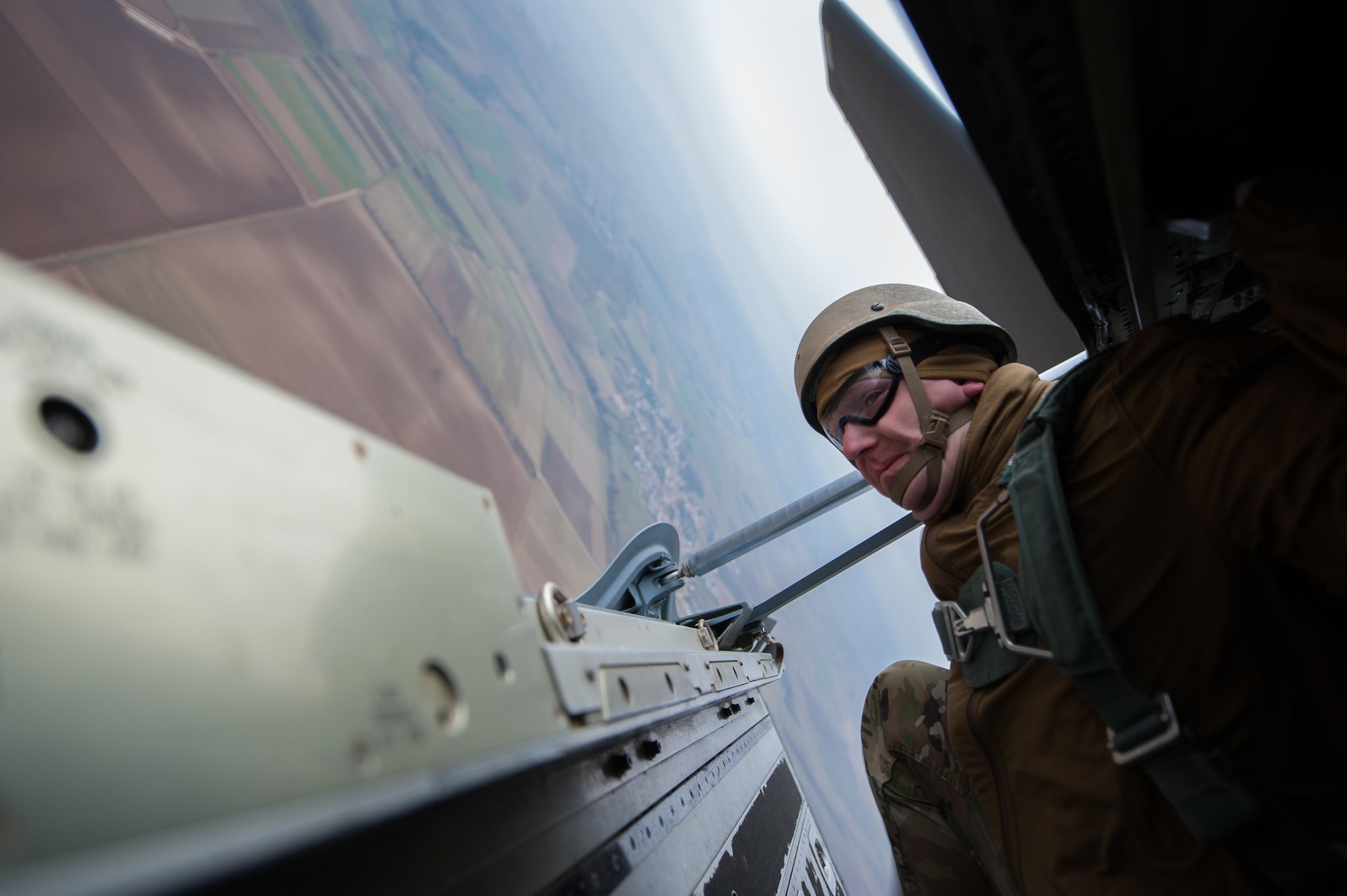 A U.S. Army soldier looks out the sides of a ramp of a C-130J Super Hercules before paratroopers jump out during an International Jump Week exercise over Germany Dec. 1, 2016. As part of the exercise, Ramstein Air Base assisted by providing aircraft for the paratroopers to jump from. (U.S. Air Force photo by Airman 1st Class Lane T. Plummer)