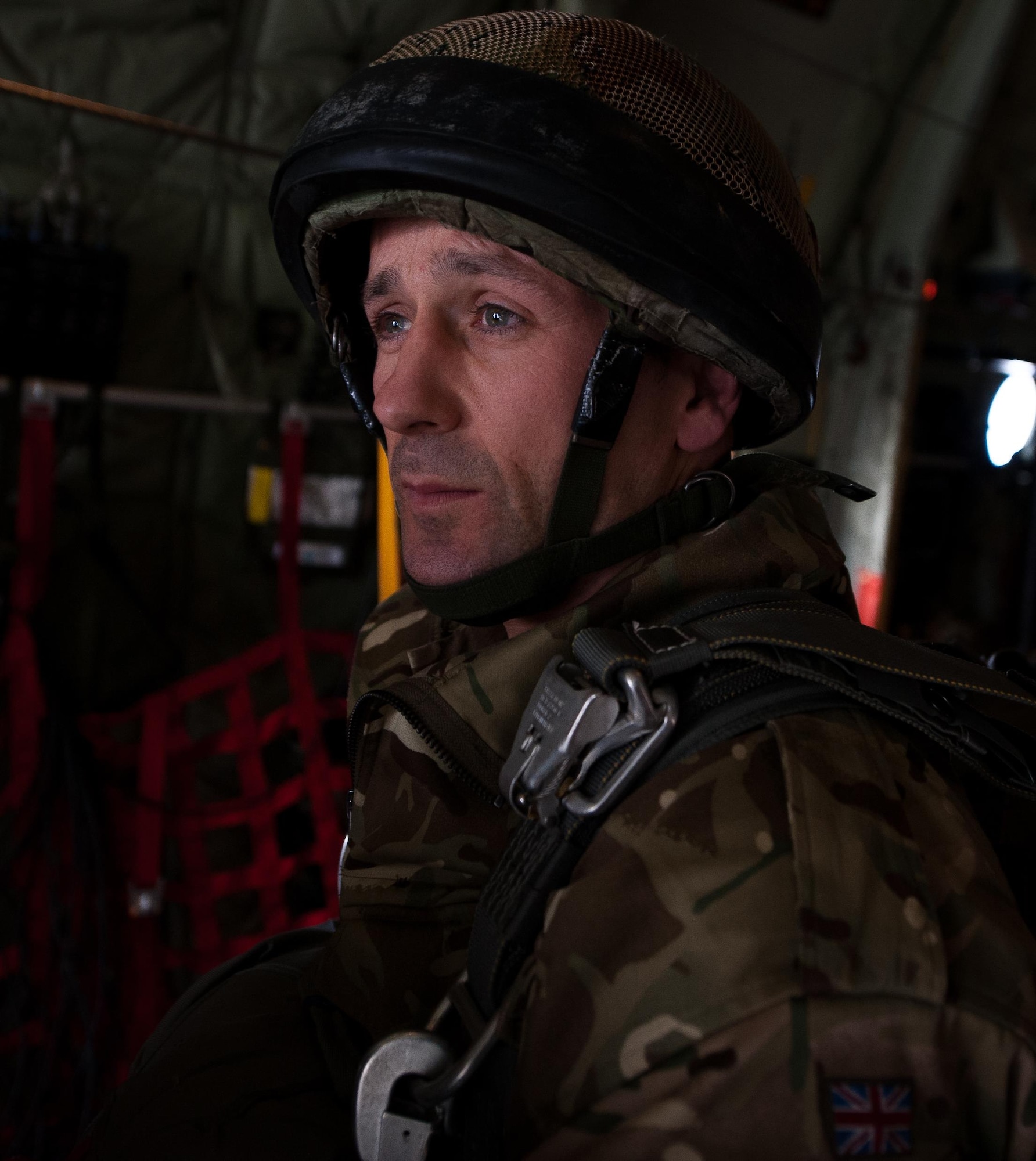 A U.K. Royal Army soldier looks out the back of a C-130J Super Hercules as he and his unit prepare to jump out of it during an International Jump Week exercise over Germany Dec. 1, 2016. Approximately a dozen NATO allies sent troops to participate in the exercise. (U.S. Air Force photo by Airman 1st Class Lane T. Plummer)