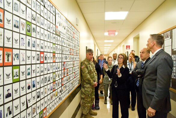 Todd Weiler, Assistant Secretary of Defense for Manpower and Reserve Affairs, and Ronald Keohane, Deputy Assistant Secretary of Defense for Military Community and Family Policy; listen to Deborah Skillman, Director, Casualty, Mortuary Affairs and Military Funeral Honors from the Office of the Deputy Assistant Secretary of Defense for Military Community and Family Policy, explain the display board of confirmed USS Oklahoma (BB 37) remains identified by the Armed Forces DNA Identification Laboratory Nov. 4, 2016, at Armed Forces Medical Examiner System on Dover Air Force Base, Del. Weiler and Keohane received briefings and met with personnel at the Air Force Mortuary Affairs Operations, AFMES and the Joint Personal Effects Depot. (U.S. Air Force photo by Roland Balik)