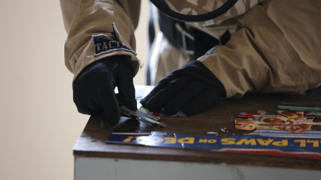 A Marine completes a puzzle to test his dexterity during a field exercise at Marine Corps Outlying Field Atlantic Nov. 30, 2016. Twenty-two Marines with Chemical, Biological, Radiological and Nuclear Defense, 2nd Marine Aircraft Wing, conducted a week-long annual training exercise that refreshed the defense specialists on the roots of their basic military occupational specialty training. The exercise included an assortment of stations and classes that tested the Marines physically and mentally. 