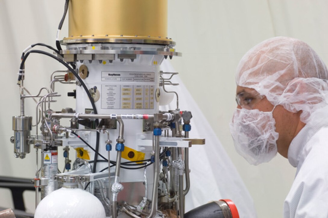 In Raytheon's Space Factory in Tucson, Arizona, a technician inspects an exo-atmospheric kill vehicle, which travels through space to track and attack enemy missiles. Courtesy photo