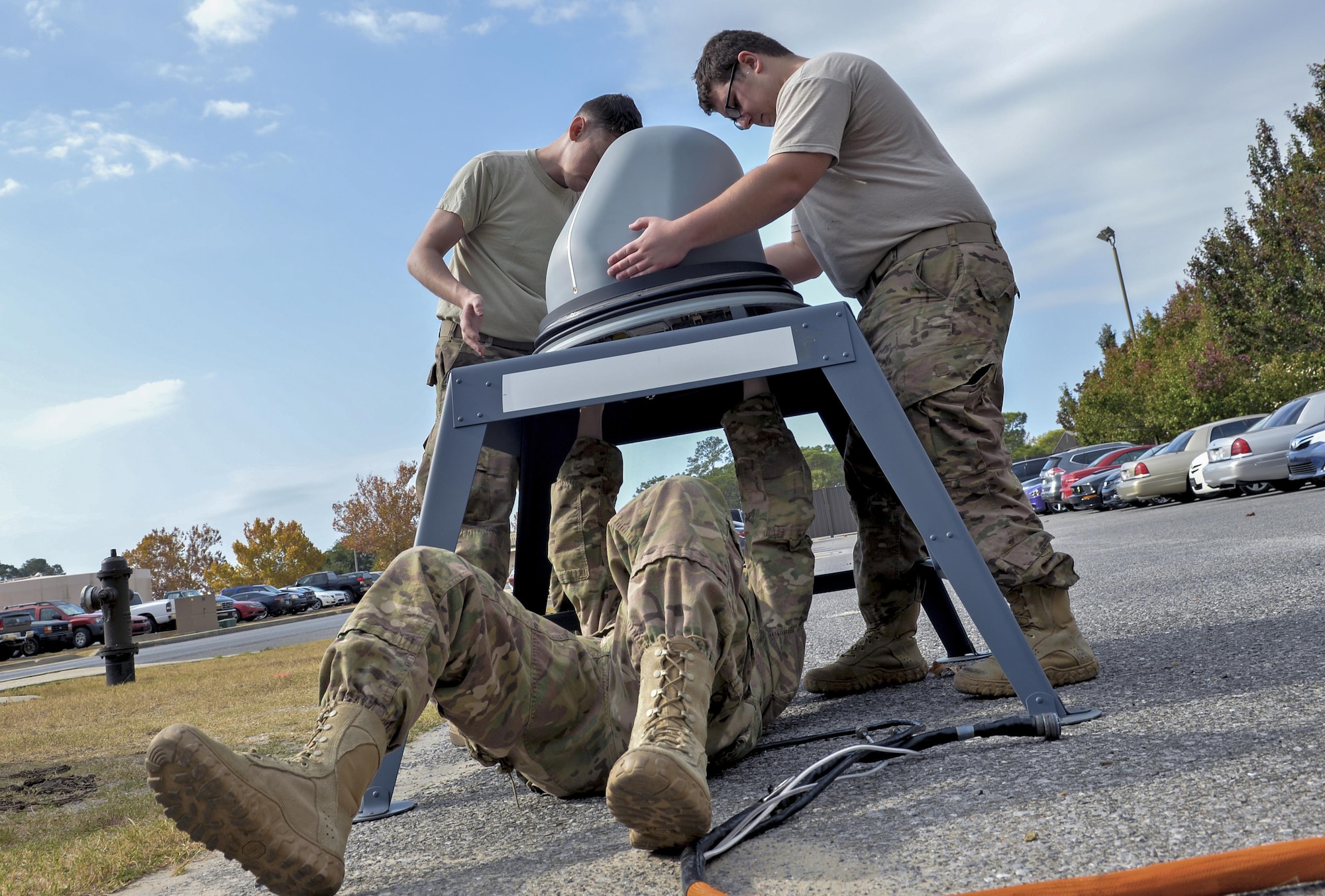 Air Commandos with the 1st Special Operations Communications Squadron, secure a Ku Spread Spectrum antenna to a stand to conduct an operational check at Hurlburt Field, Fla., Nov. 29, 2016. The KuSS Antenna is an airborne broadband satellite communication system that transmits data, such as full motion video that is crucial to real time decision making, from pilots to command and control sites where deployed units are operating. (U.S. Air Force photo by Senior Airman Andrea Posey)