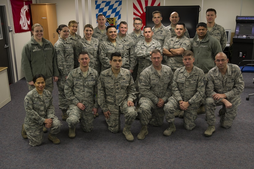 Members of the 4th Combat Camera Squadron pose for a group photo during the 315th Airlift Wing's December unit training assembly. The 4th Combat Camera Squadron and its Airmen found a new home this weekend with the 315th Airlift Wing at Joint Base Charleston. The 4th CTCS, which was formally assigned to March Air Reserve Base in Riverside, Calif., deactivated in July 2015, but was reactivated and relocated to the 315 AW due to mission need. (U.S. Air Force Photo by Senior Airman Jonathan Lane)