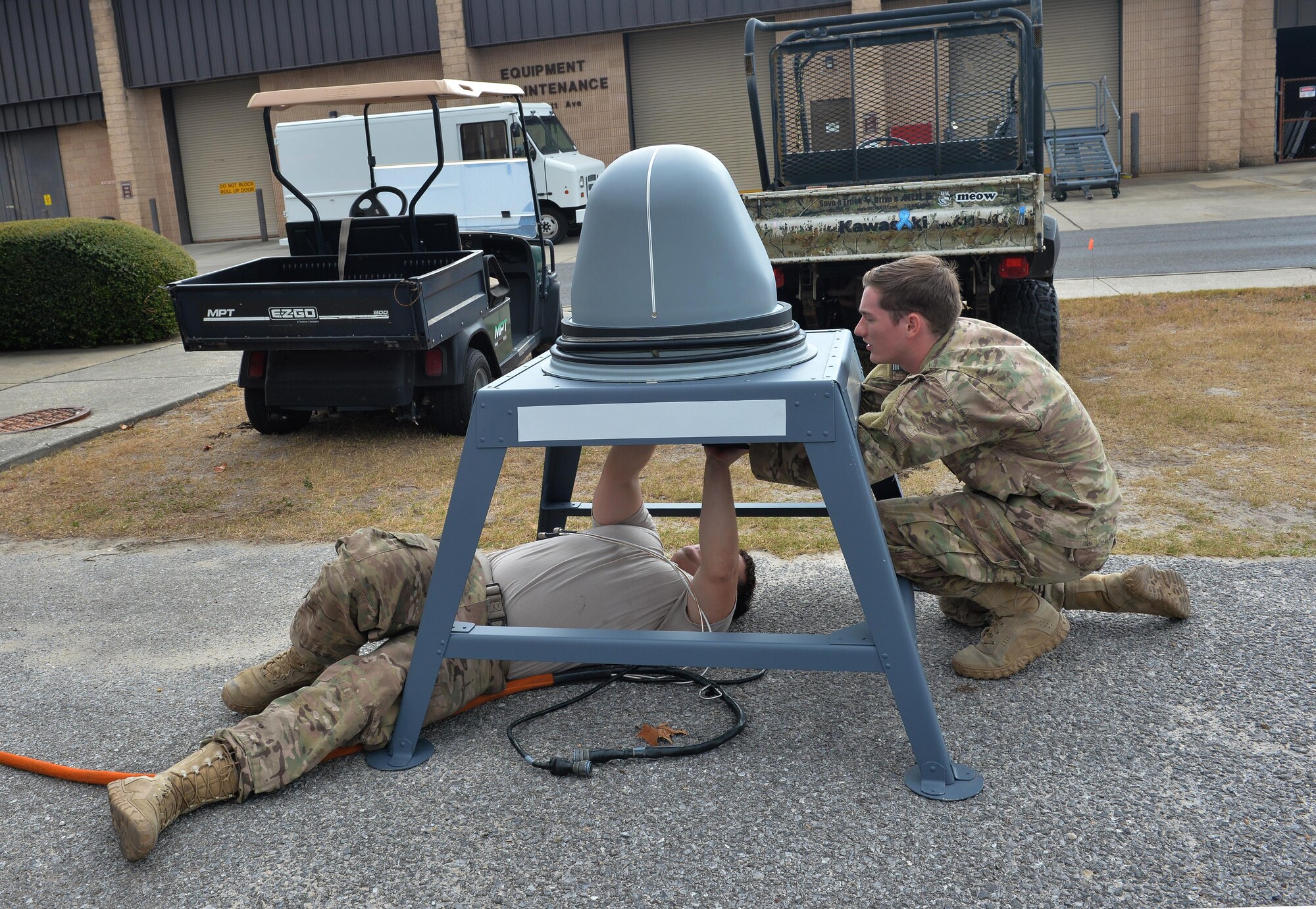 Senior Airmen Tyler Gray, left, and Daniel Burkemper, cyber transport system technicians with the 1st Special Operations Communications Squadron, conduct an operations check on a Ku Spread Spectrum antenna at Hurlburt Field, Fla., Nov. 29, 2016. The KuSS Antenna is an airborne broadband satellite communication system that transmits data, such as full-motion video that is crucial to real-time decision making, from pilots to command and control sites where deployed units are operating. (U.S. Air Force photo by Senior Airman Andrea Posey)