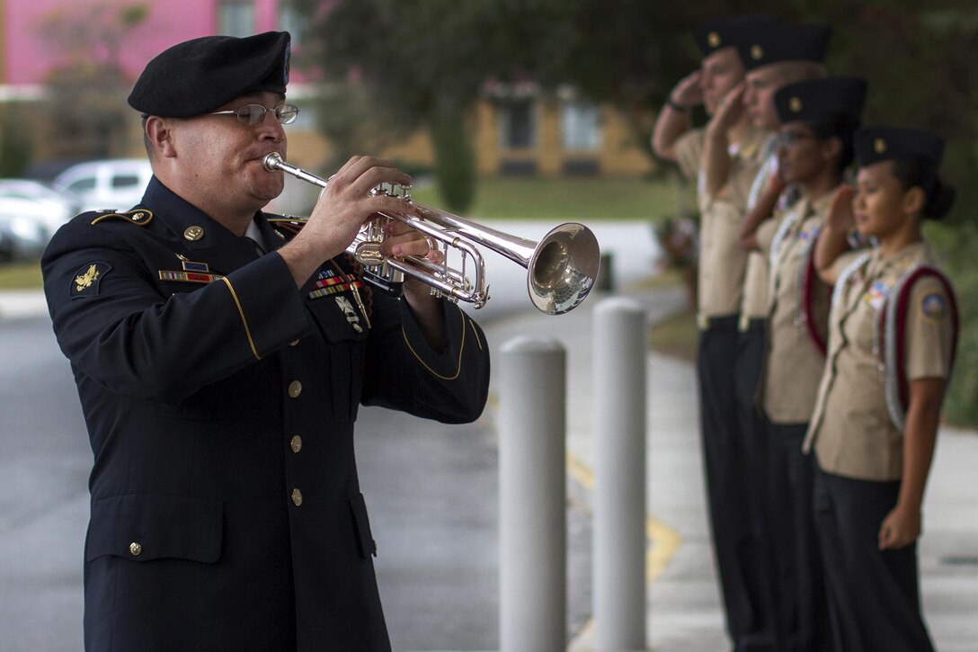 Army Spc. Matthew Rodriguez plays taps in honor of the fallen during the Pearl Harbor remembrance ceremony at the National Museum of the Mighty Eighth Air Force in Pooler, Georgia, Dec. 4, 2016. Rodriguez is a musician assigned to the 3rd Infantry Division’s band. Army photo by Sgt. William Begley