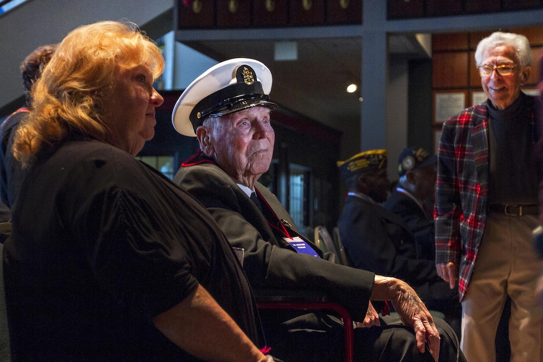 Retired Navy Chief Petty Officer Glover Manning, center, an engineman aboard the USS Rigel during the Pearl Harbor attack, sits with his family before being honored at the National Museum of the Mighty Eighth Air Force in Pooler, Georgia, Dec. 4, 2016. Army photo by Spc. Scott Lindblom