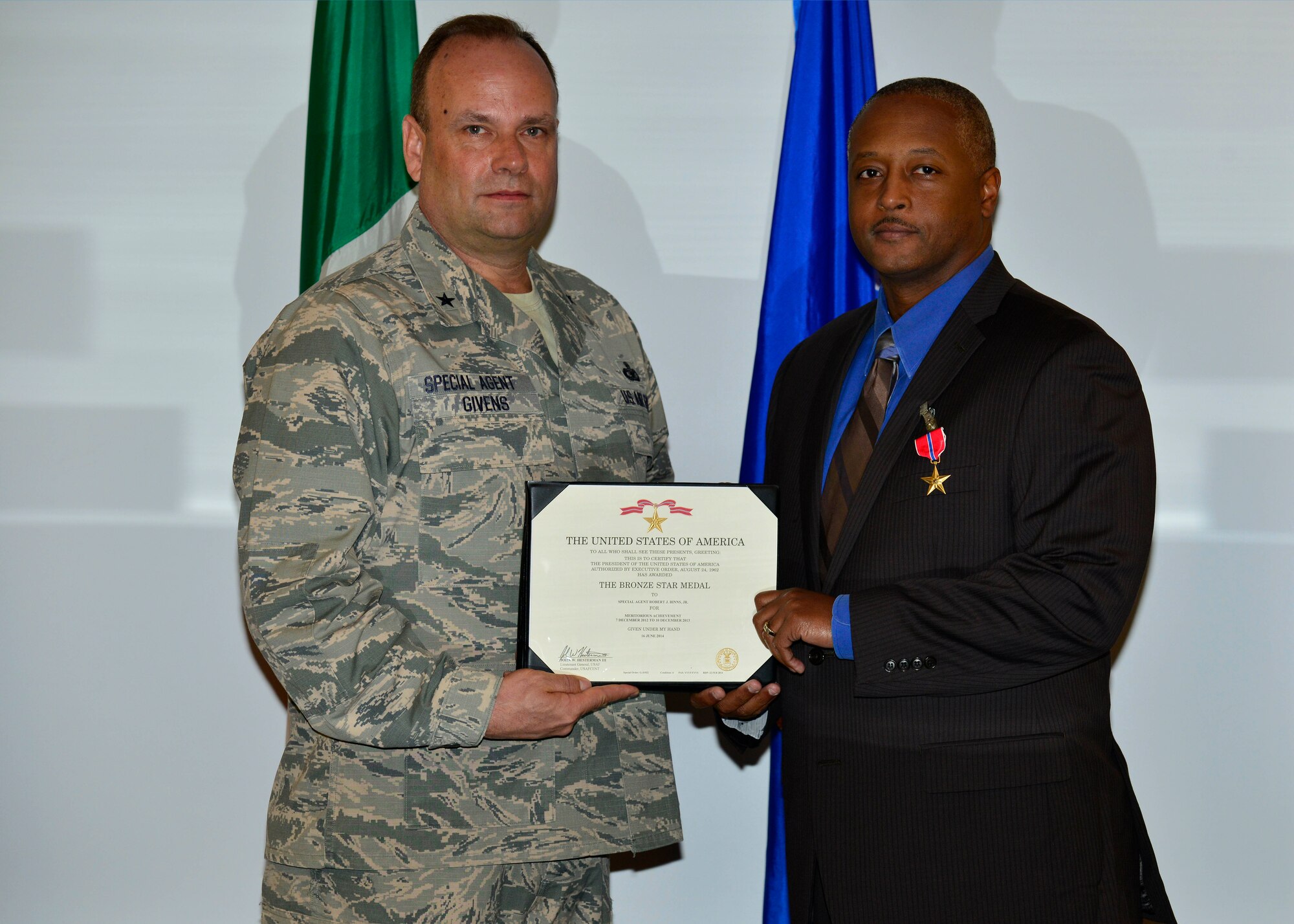 Brig. Gen. Keith Givens, Air Force Office of Special Investigations commander, presents the Bronze Star Medal certificate to Special Agent Robert Binns, AFOSI Detachment 531 superintendent, at Aviano Air Base, Italy on Dec. 5, 2016. Binns earned the medal by distinguishing himself by meritorious achievement while engaged in operations against an opposing force in Afghanistan from Dec. 7, 2012 to Dec. 10, 2013. (U.S. Air Force photo by Senior Airman Cary Smith)