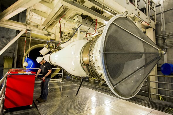 Tyler Holes, an Arnold Engineering Development Center engineer, assists in preparing for testing of the TF33 Pratt and Whitney engine in one of the AEDC sea level test cells in Tennessee. Testing is being conducted at AEDC to verify and validate newly redesigned components of the TF33 engine. (U.S. Air Force photo/Rick Goodfriend)