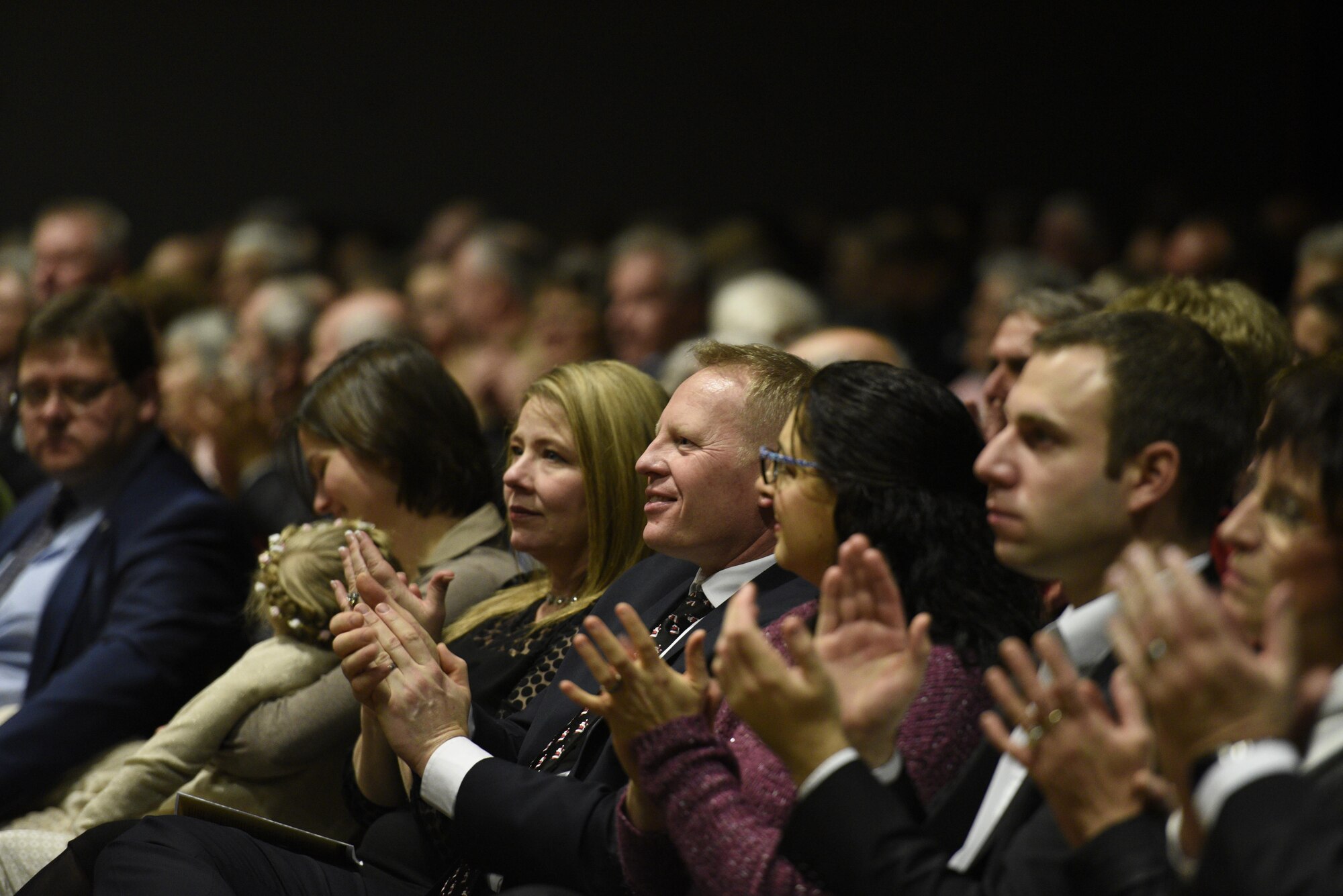 Col. Joe McFall, center, 52nd Fighter Wing commander, attends the U.S. Air Forces in Europe Concert band at City Hall, Bitburg, Germany, Dec. 3, 2016. The band played holiday songs as a way to say thank you to the community members who support USAFE installations. (U.S. Air Force photo by Staff Sgt. Jonathan Snyder)