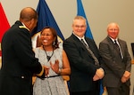 Army Brig. Gen. Charles Hamilton, DLA Troop Support commander, congratulates Mara Bailey, John McAndrews and Gary Shute during the DLA Troop Support Hall of Fame induction ceremony Nov. 29.