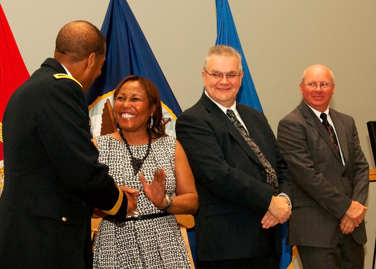 Army Brig. Gen. Charles Hamilton, DLA Troop Support commander, congratulates Mara Bailey, John McAndrews and Gary Shute during the DLA Troop Support Hall of Fame induction ceremony Nov. 29.