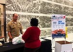 Navy Lt. Anthony Meyer speaks with an employee working at One Liberty Place in downtown Philadelphia Nov. 8. Meyer, a contract specialist with Subsistence, gave her a handful of cards for her co-workers to sign and include in care packages for warfighters as part of Operation Gratitude.