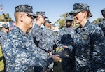 Sailors greet one another during a commissioning ceremony Nov. 10, 2016 in San Diego. DLA Troop Support led a Joint Clothing and Textiles Governance Board meeting Nov. 17 with Department of Defense senior logistics leaders to discuss management of clothing and textiles, such as the Navy Working Uniform shown here, during an executive board in Alexandria, Virginia. 