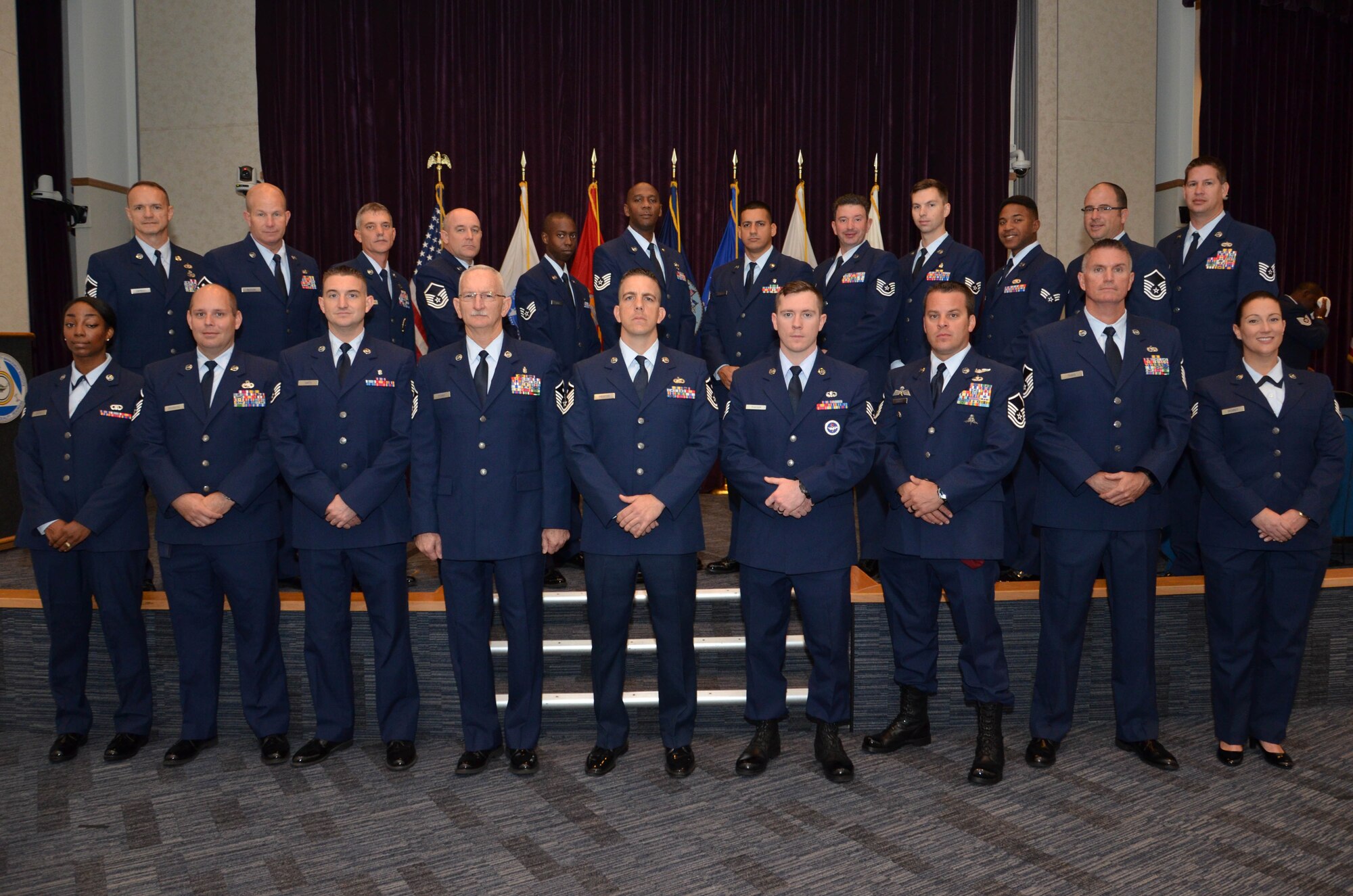 Twenty-one Air Force Reserve Airmen from the 920th Rescue Wing, Patrick Air Force Base, Florida, received their Associate of Applied Science degrees from the Community College of the Air Force Dec. 4 during a ceremony at the Defense Equal Opportunity Management Institute here. 
During the ceremony, Col. Brett Howard, the 920th RQW vice wing commander, presented the diplomas while 920th RQW Command Chief Timothy Bianchi presented special coins to each graduate.

