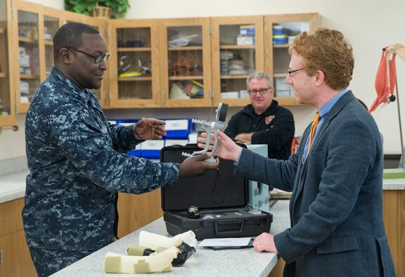 Petty Officer 1st Class Derrick Charles, Naval Training Support Center instructor, tests the grip strength of Johnathan Cristol, World Policy Institute fellow, during an occupational therapy demonstration at the Medical Education and Training Campus Nov. 30, 2016 at Joint Base San Antonio-Ft. Sam Houston, Texas. The civic leaders also toured a C-5M Super Galaxy aircraft, the Medical Training and Education Campus at Joint Base San Antonio-Ft. Sam Houston, and the Center for the Intrepid. (U.S. Air Force photo by Benjamin Faske)